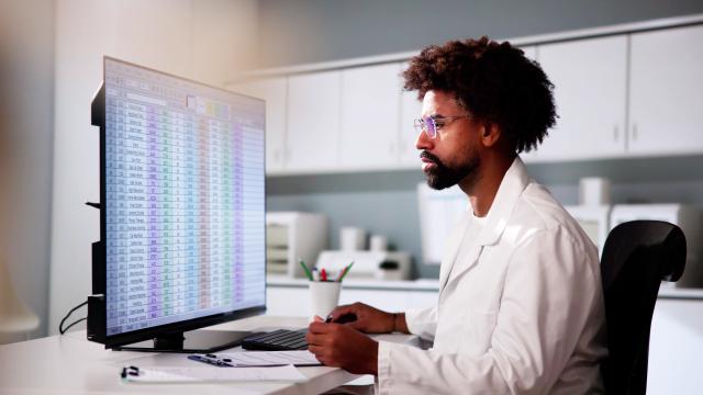 person looking at a computer screen in a medical setting.