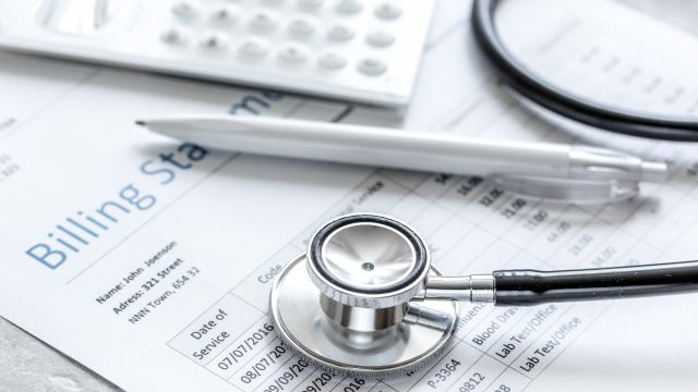 Stethoscope and pen over medical documents