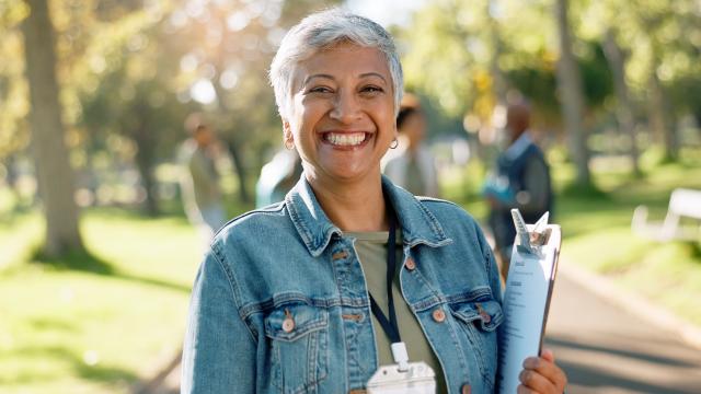 A person smiling with a clipboard