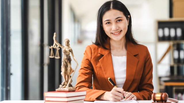 Paralegal sitting at desk with paperwork